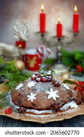 Christmas pudding on a platter on the holiday table. British traditional dessert. Close-up.
