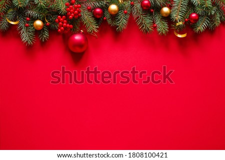 Christmas red background with christmas decorations, top view with space for text.