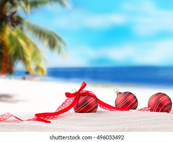 Christmas Red Balls, Ornament On A Beach - Concept Of A Warm Weather Christmas