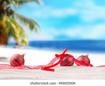 Christmas Red Balls, Ornament On A Beach - Concept Of A Warm Weather Christmas