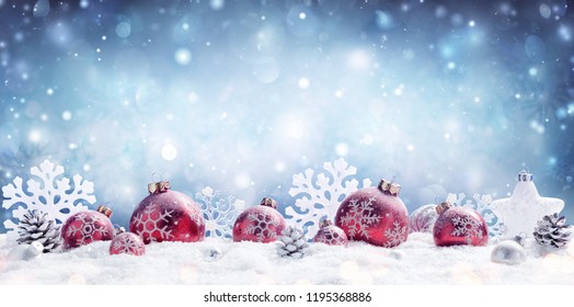 Christmas - Red Baubles Decorated And Snowflakes In Snowing Background 
				