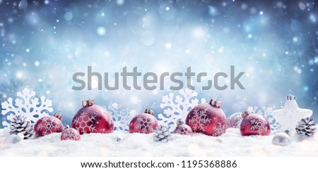Christmas - Red Baubles Decorated And Snowflakes In Snowing Background 
