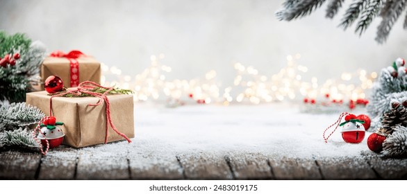 Christmas red decorations on snow with gift boxes, fir tree branches and christmas lights. Winter Decoration Background with copy space for text - Powered by Shutterstock