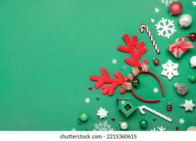 Christmas Reindeer Horns With Decor On Green Background