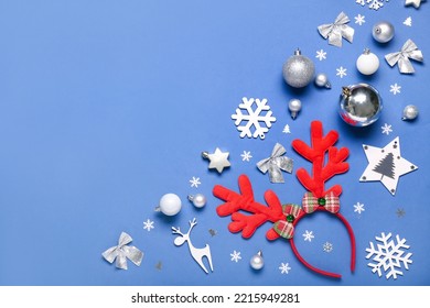 Christmas Reindeer Horns With Decor On Blue Background