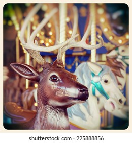 A Christmas reindeer on a carousel ride. Processed  and filtered to look like an aged instant photo.