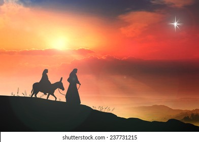 Christmas religious nativity concept: Silhouette pregnant Mary and Joseph with a donkey on night background