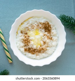 Christmas Rice Porridge With Butter And Cinnamon On Blue Textile Background, Top View