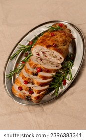 Christmas roll of turkey fillet stuffed with mushrooms and cheese with cranberries and rosemary - Shutterstock ID 2396383341