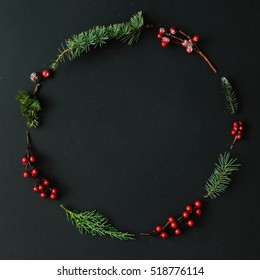 Christmas round frame made of natural winter things on dark blackboard. Flat lay. Christmas concept.
