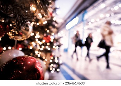Christmas rush, Christmas lights with  silhouettes of defocused shoppers in a shopping mall