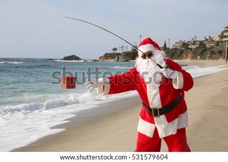 Christmas Santa Claus Fishing for Xmas Presents with his Fishing Pole. Santa Catches a present while fishing.