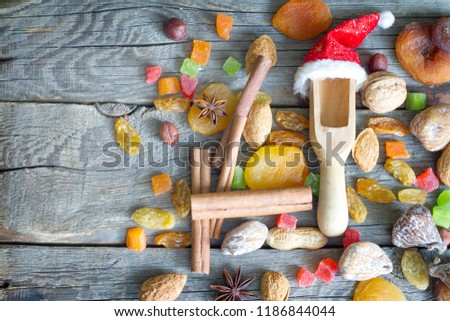 Christmas Santa Claus hat with dried fruits and nuts on wooden background