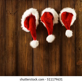 Christmas Santa Claus Hats Hanging Xmas Family On Wood Wall Background