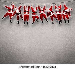 Christmas Santa Hanging On Rope. Funny Concept Background.