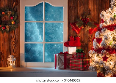 Christmas Scene With Tree Gifts And Frozen Window In Background