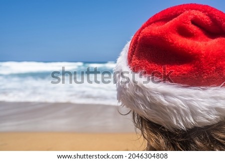 Christmas sea holiday. Woman in santa hat relaxing on paradise beach island getaway. New year