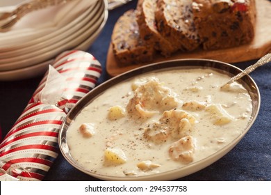 Christmas Seafood Chowder Served With Fruitcake And Christmas Crackers.