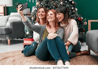 Christmas selfie, happy and women in home for celebration together and social media update for memory. Female people, smile and group of friends for festive holiday party or video call with contact - Powered by Shutterstock