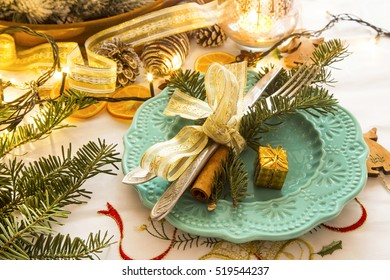 Christmas setting with silver balls and ribbon, festive table,fir tree branches with fork and knife - Powered by Shutterstock