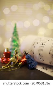 Christmas Sheet Music. Christmas Decorations On Music Sheets, Closeup

