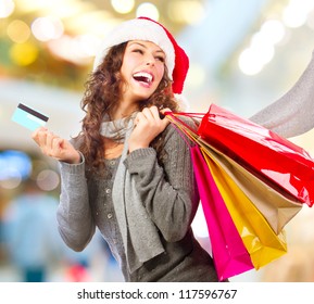 Christmas Shopping. Beautiful Happy Girl With Credit Card In Shopping Mall. Shopping Bags. Shopping Center. Christmas Sales