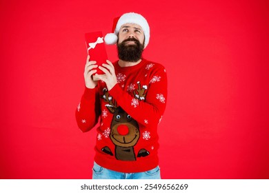 Christmas shopping sale. Happy New Year. Xmas holiday present. Santa Claus man at New Year sale. Santa man hold holiday shopping gift isolated on red. Xmas present and gift. Exchange gifts - Powered by Shutterstock