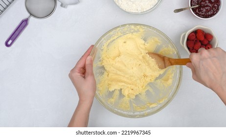 Christmas Shortbread Cookies With Raspberry Preserves Recipe. Chef Mixing Ingredients In A Glass Bowl, Close Up View From Above