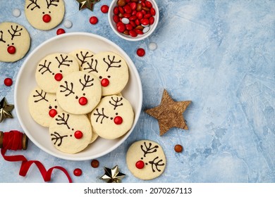 Christmas shortbread  cookies reindeer Rudolph on a blue background. Children's festive dessert. Top view, copy space.  - Powered by Shutterstock