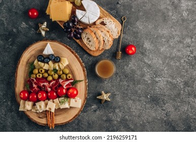 Christmas snack tree on dark concrete background. Cheese plate. Christmas food concept. Top view - Shutterstock ID 2196259171