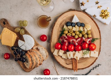 Christmas Snack Tree On Rustic Wooden Board Over Beige Stone Background. Cheese Plate. Christmas Food Concept. Top View