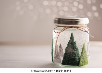 Christmas snow globe handmade of used glass bottle - Powered by Shutterstock
