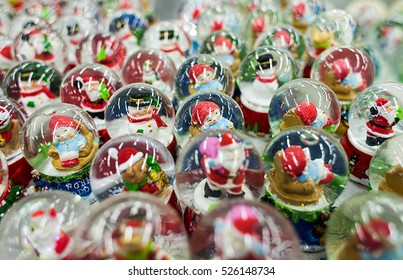 A lot of Christmas snow globes with Santa Clauses inside - Powered by Shutterstock