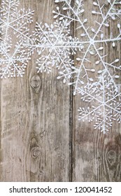 Christmas snowflakes on a wooden background