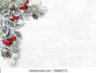 Christmas Snowy Branches With Holly And Cones On White Wood Background