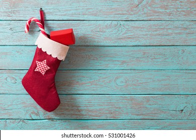 Christmas Sock With Gifts On  Wooden Wall