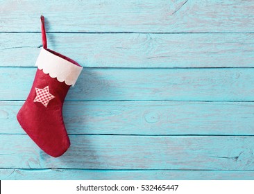 Christmas sock with gifts on  wooden wall - Powered by Shutterstock