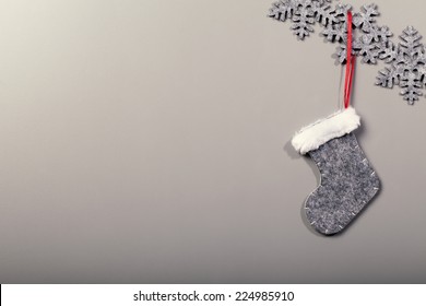 Christmas sock hanging on snowflake pattern on clean background, vintage cool instagram filter look - Powered by Shutterstock