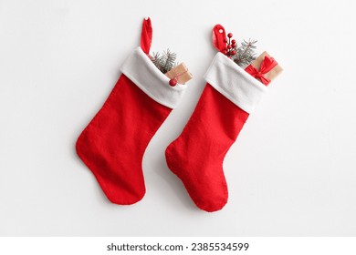 Christmas socks with fir branch, rowan and gift box hanging on white background - Powered by Shutterstock