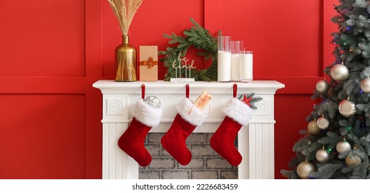 Christmas socks with gifts on fireplace in living room - Powered by Shutterstock