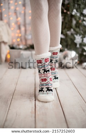 Christmas socks with reindeer, on children's feet.
