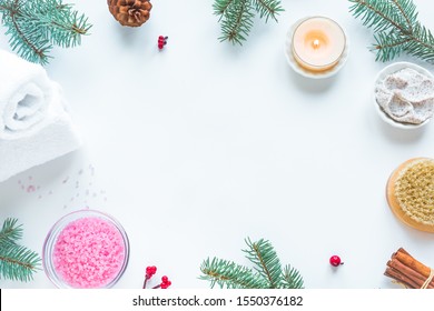 Christmas Spa Set, Flat Lay With Towels, Fir Branches And Candle On White Background, Copy Space. Winter Festive Relax And Spa Concept.