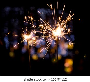 christmas sparkler on colorful lights background - Shutterstock ID 116794312