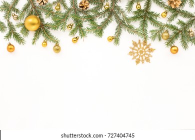 Christmas spruce branches, golden christmas decorations on white background, flat lay, top view.  - Powered by Shutterstock