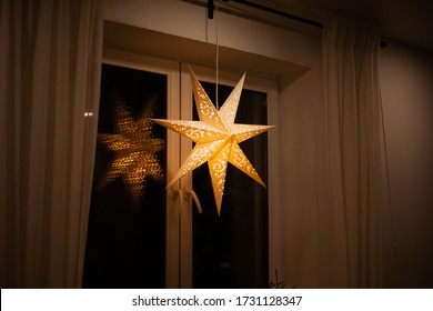 A Christmas Star In The Window. Warm Light, Christmas, Cosy Atmosphere. Advent Time.