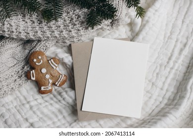 Christmas Still Life. Blank Greeting Card, Invitation Mockup With Craft Envelope.,Gingerbread Man Cookie And Fir Tree Branches. White Muslin Table Cloth, Throw. Flatlay, Top View. Winter Holiday.