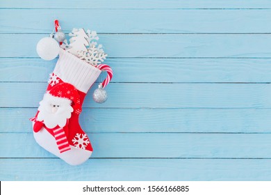 Christmas Stocking With Gifts Hanging On Blue Wooden Background