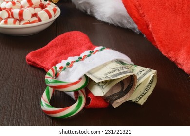 A Christmas Stocking With Money And Candy Canes In It