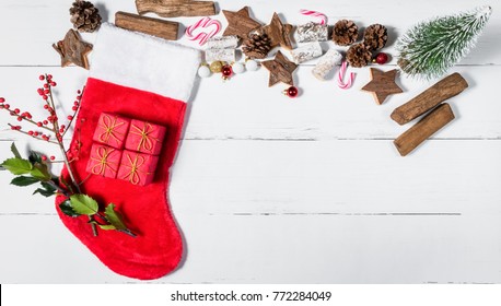 Christmas Stocking And Ornaments On White Wooden Table 