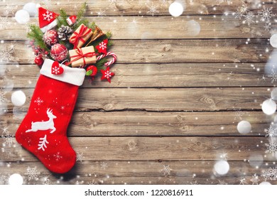 Christmas Stocking And Toys Over Rustic Wooden Background